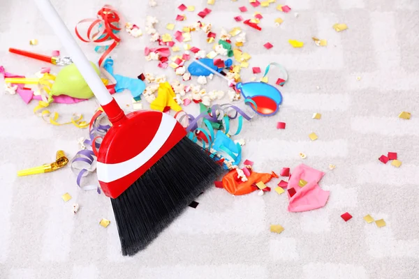 Sweeping trash after party with bristle broom indoors — Stock Photo, Image