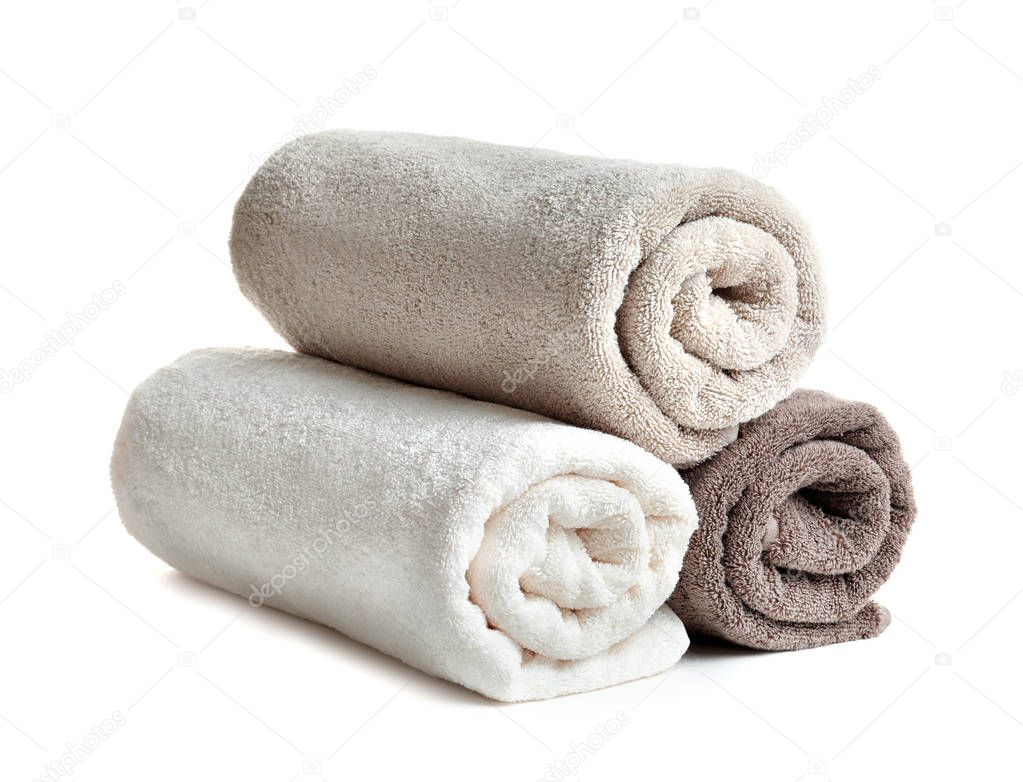 Rolled soft terry towels on white background