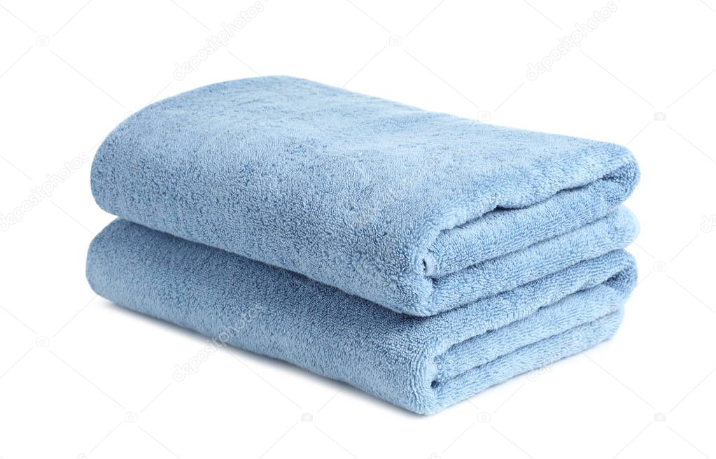 Folded clean soft towels on white background