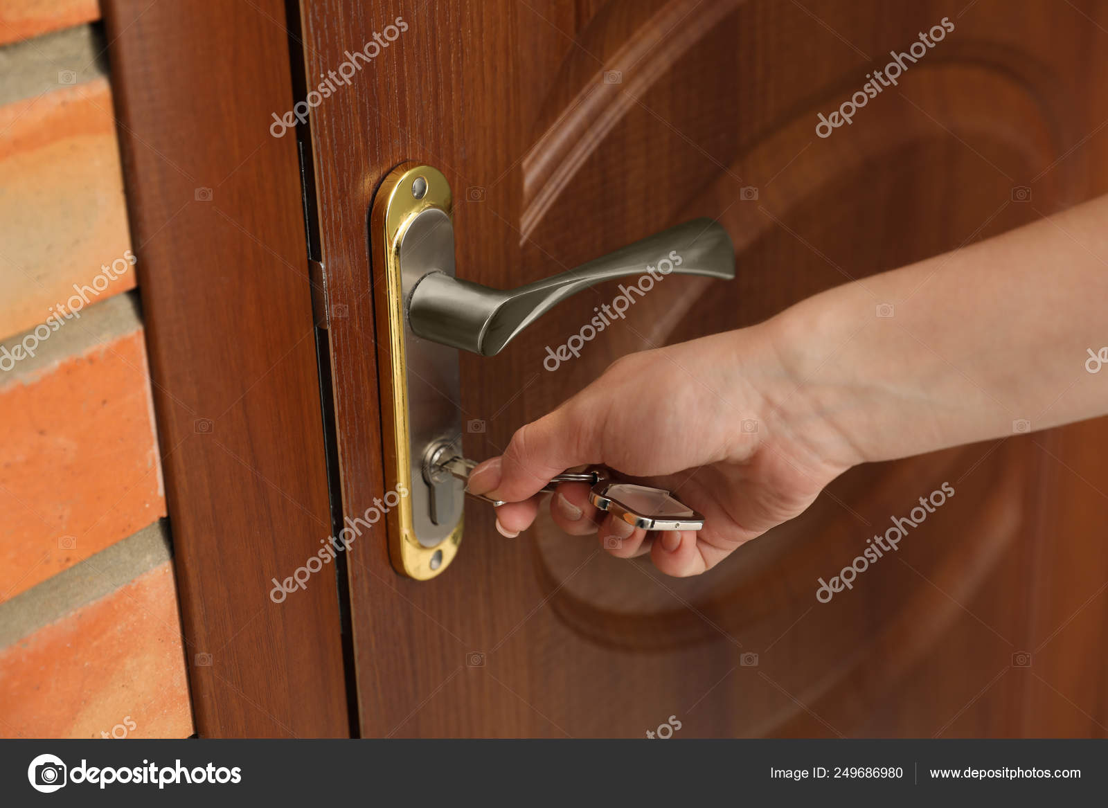 Woman With Key Opening Front Door Closeup Stock Photo