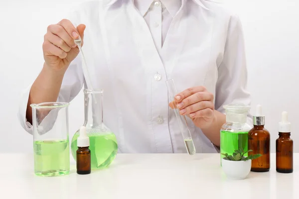 Female dermatologist creating skin care product at table, closeup — Stock Photo, Image