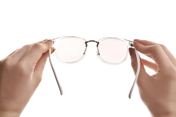 Female ophthalmologist holding glasses on white background, closeup — Stock Photo, Image