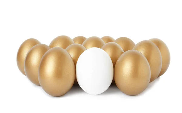 Golden eggs with different one on white background — Stock Photo, Image