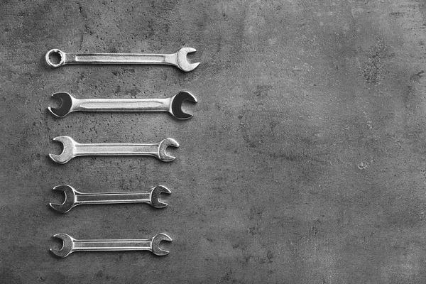 New wrenches on grey background, top view with space for text. Plumber tools — Stock Photo, Image