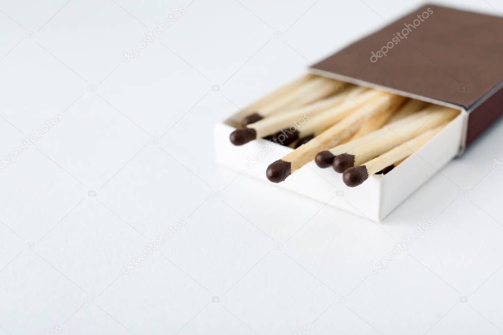 Cardboard box with matches on light background