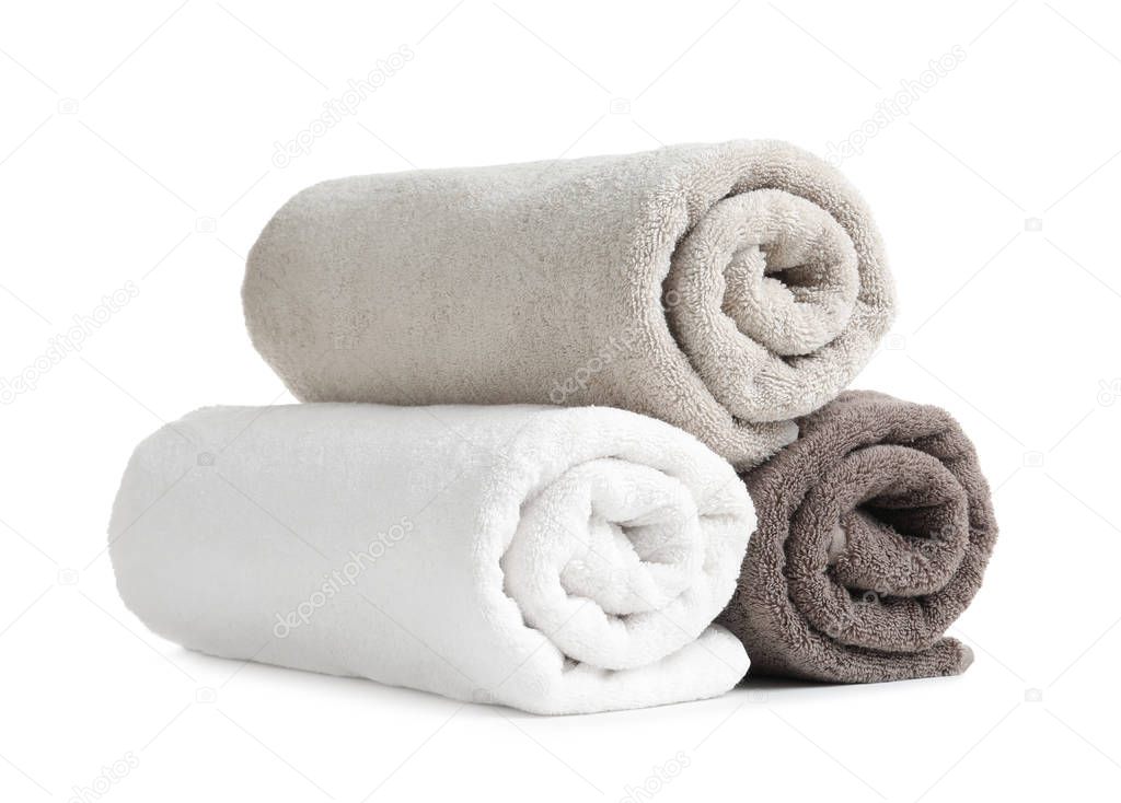 Rolled soft terry towels on white background