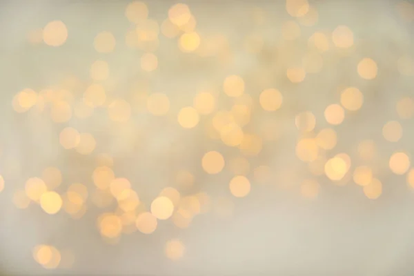 Gold glitter with bokeh effect on light background — Stock Photo, Image