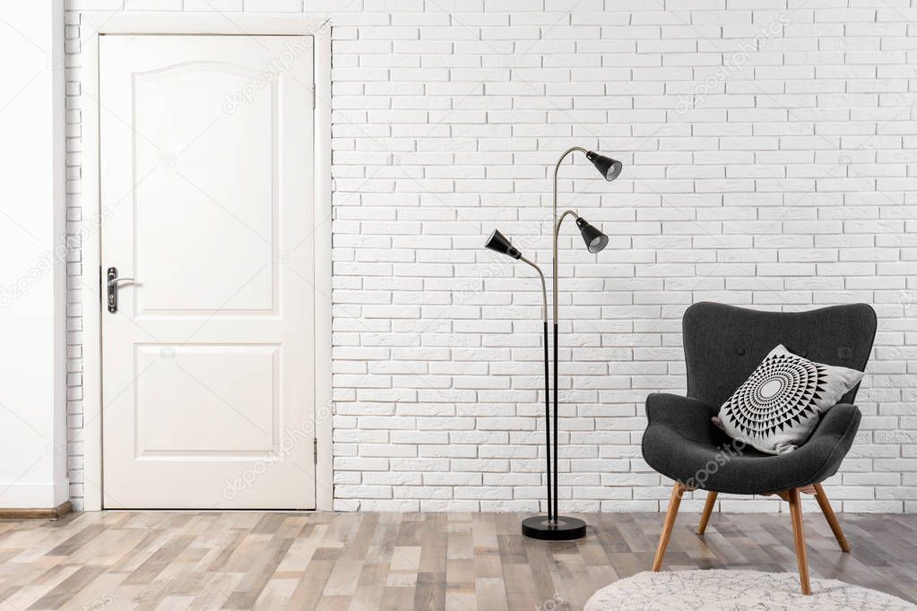Light room interior with white door in brick wall