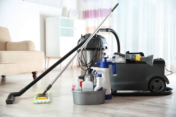 Professional cleaning supplies and equipment on floor indoors — Stock Photo, Image