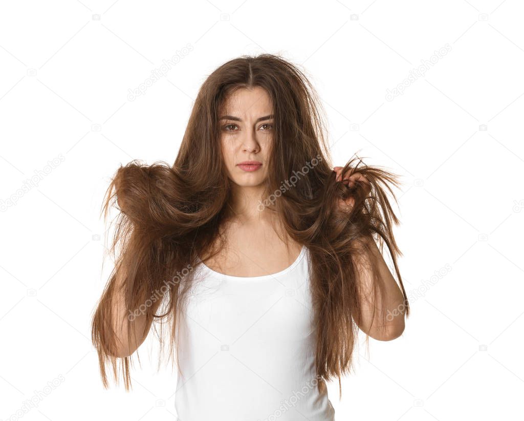 Emotional woman with tangled hair on white background