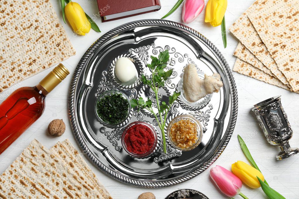 Flat lay composition with symbolic Passover (Pesach) items and meal on color background