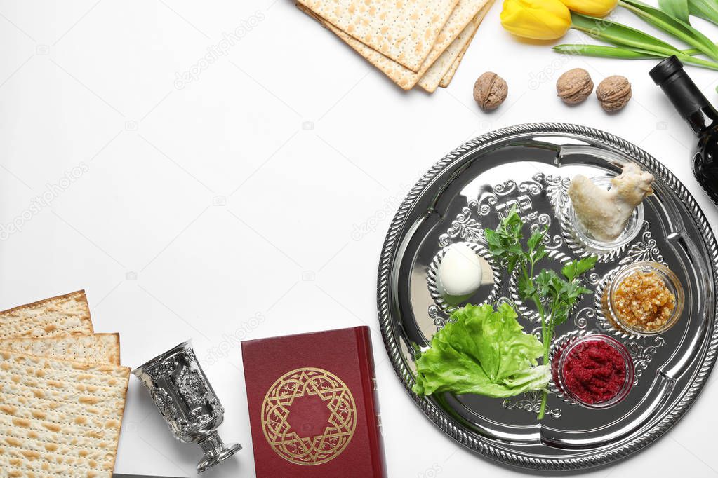 Flat lay composition with symbolic Passover (Pesach) items and meal on white background