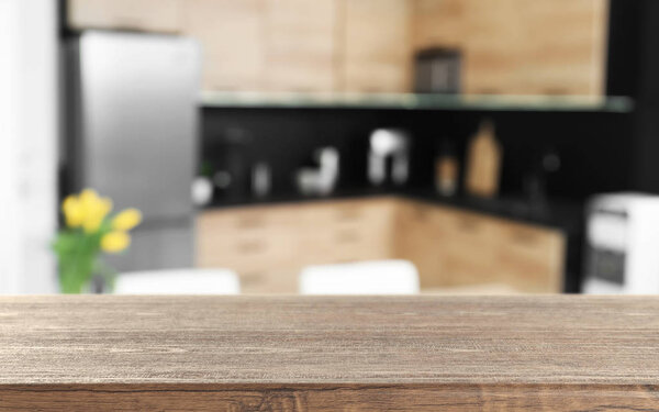 Empty brown wooden table in modern kitchen. Mockup for design