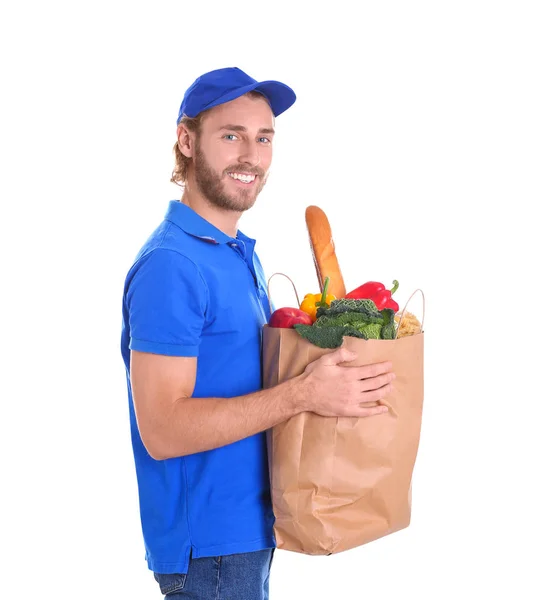 Delivery man holding paper bag with food products on white background — Stock Photo, Image