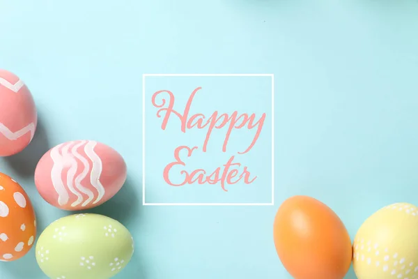 Színes festett tojások és színes háttéren Boldog húsvéti szöveg lapos laikus összetétele — Stock Fotó