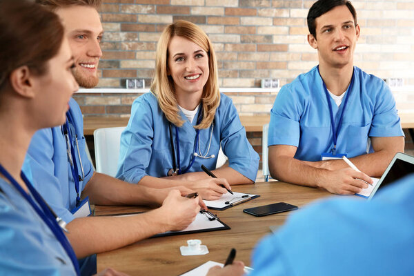 Medical students in uniforms studying at university