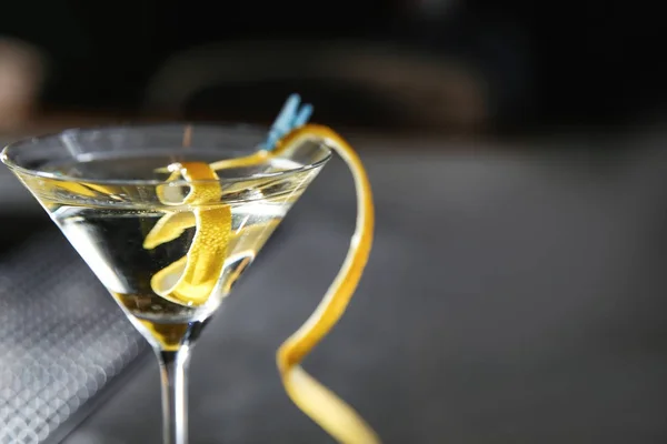 Glass of lemon drop martini cocktail in bar, closeup. Space for text — Stock Photo, Image