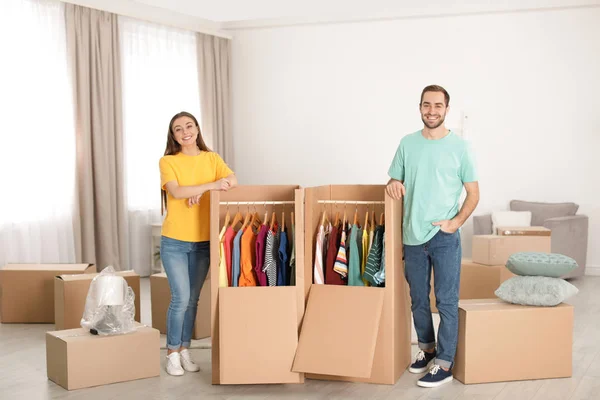 Young couple near wardrobe boxes at home