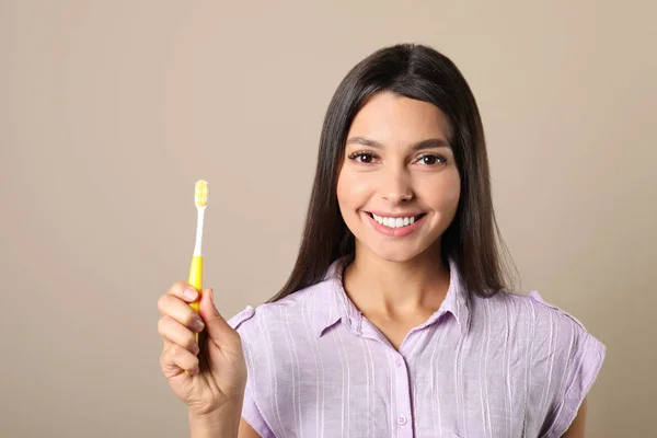 Young woman with toothbrush on color background. Teeth care — Stock Photo, Image