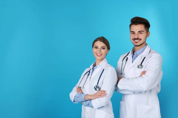 Happy young medical students on color background. Space for text — Stock Photo, Image