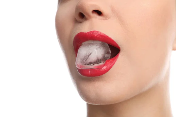 Young woman holding ice cube in mouth on white background, closeup — Stock Photo, Image