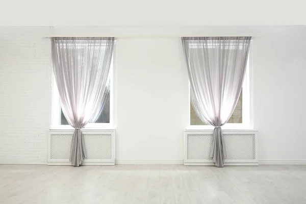 Modern windows with curtains in room. Home interior