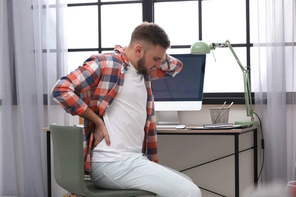 Junger Mann leidet unter Rückenschmerzen im Amt — Stockfoto