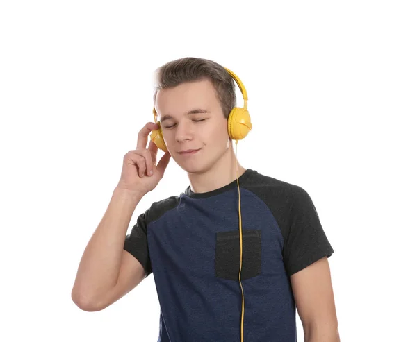 Teen boy listening to music with headphones on white background — Stock Photo, Image