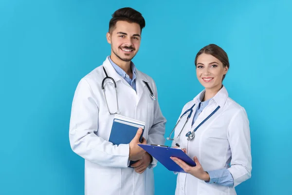 Happy young medical students on color background — Stock Photo, Image