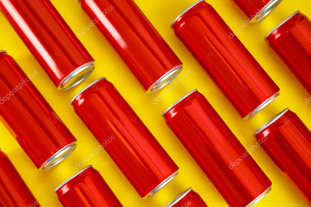 Blank metal red cans on color background, flat lay. Mock up for design