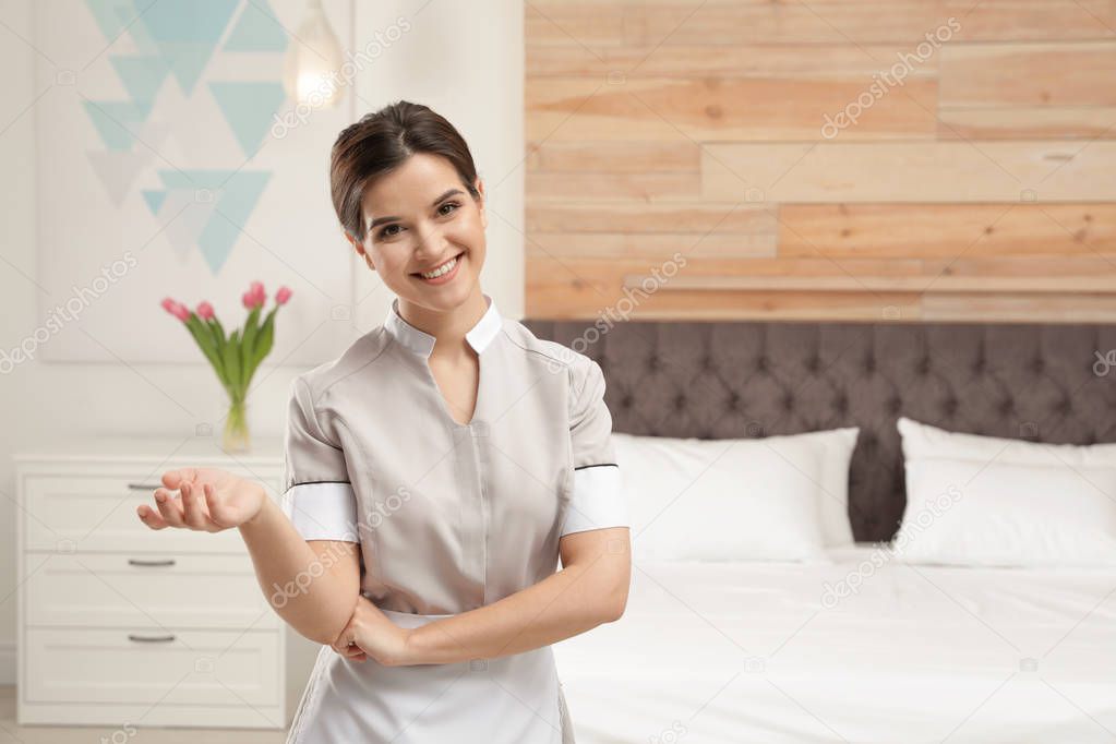 Portrait of young maid in hotel room. Space for text