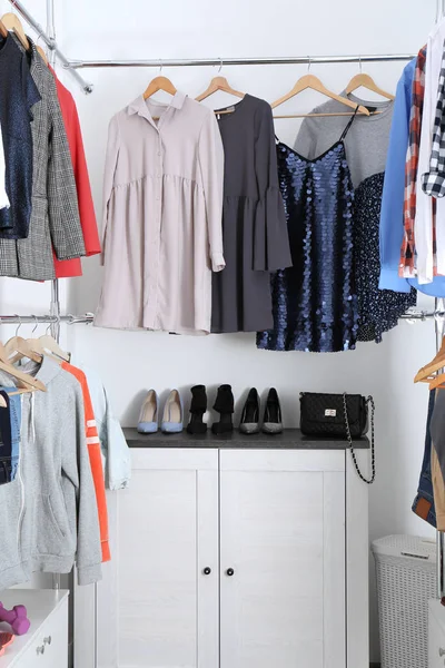 Moderno camarim com diferentes roupas e sapatos elegantes — Fotografia de Stock