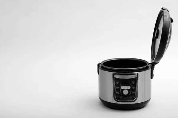 Modern electric multi cooker on light background. Space for text — Stock Photo, Image