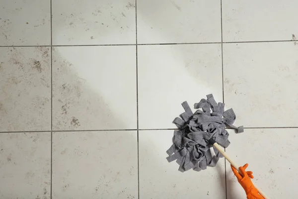 Professional cleaner washing dirty floor with mop, top view. Space for text — Stock Photo, Image