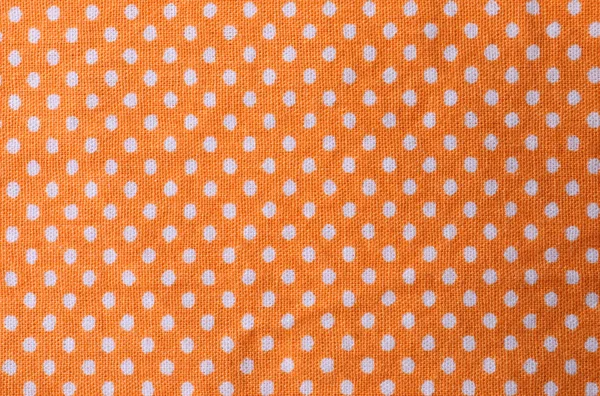 Texture of orange polka dot fabric, closeup