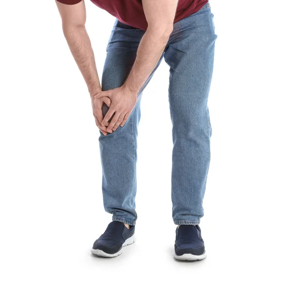 Młody człowiek cierpiący na ból nóg na białym tle, zbliżenie — Zdjęcie stockowe