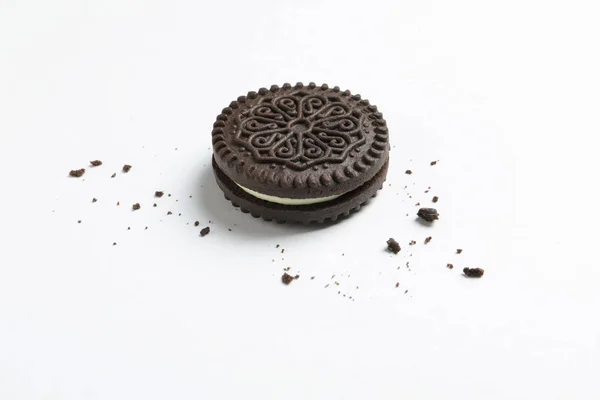 Tasty chocolate cookie and crumbs on white background — Stock Photo, Image