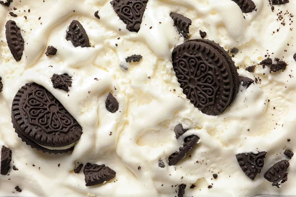 Tasty ice cream with chocolate sandwich cookies as background, top view — Stock Photo, Image