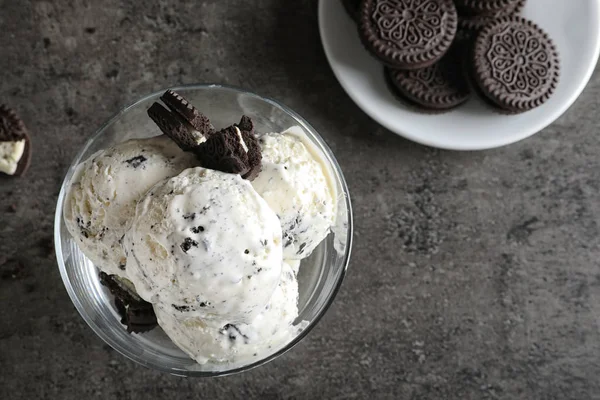 Bowl of chocolate cookies ice cream on grey background, top view with space for text — Stock Photo, Image