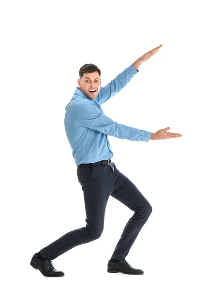 Emotional man in office wear holding something on white background — Stock Photo, Image