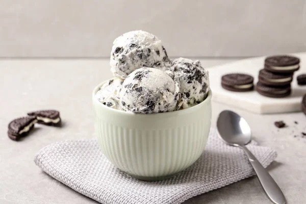 Bowl with ice cream and crumbled chocolate cookies on table — Stock Photo, Image