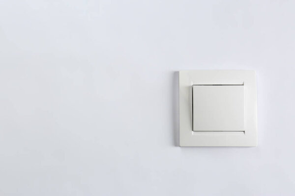 Light switch on white background. Electrician's equipment