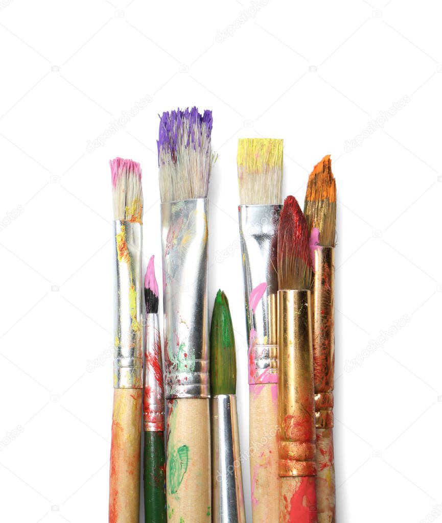 Different paint brushes on white background, top view