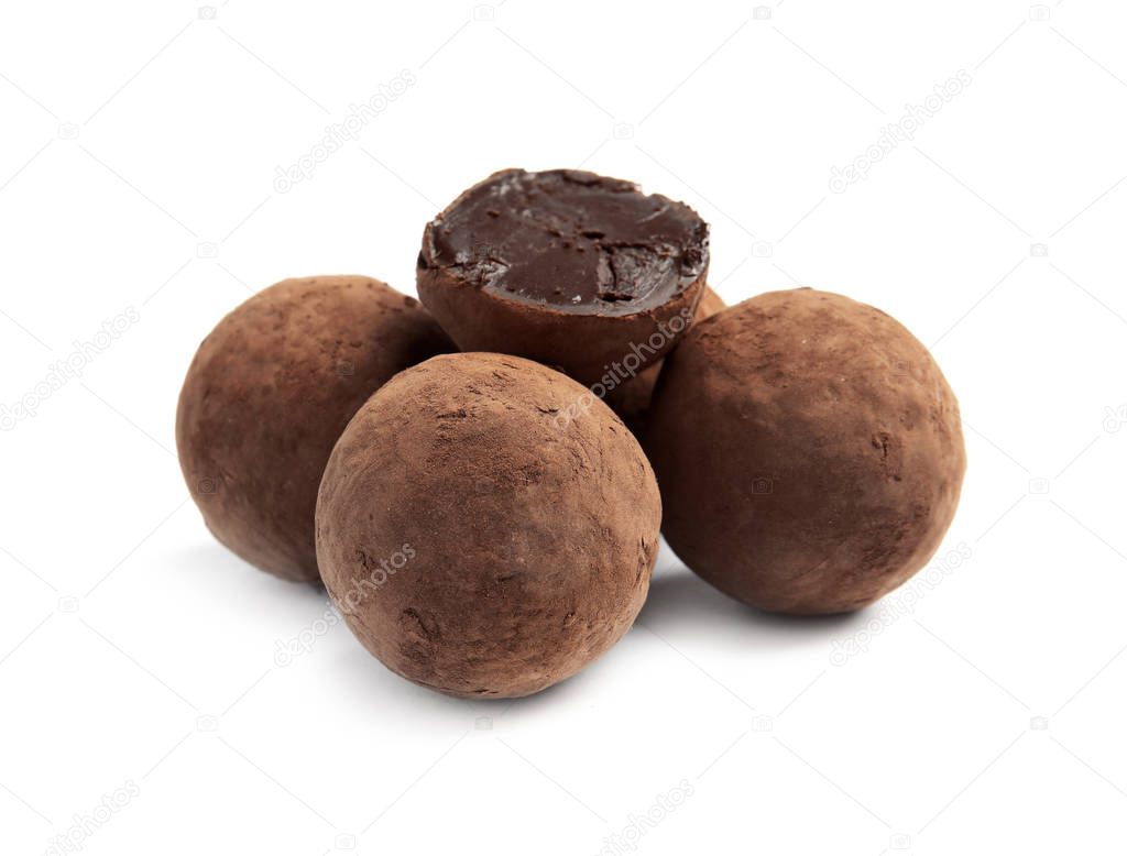 Delicious raw chocolate truffles on white background