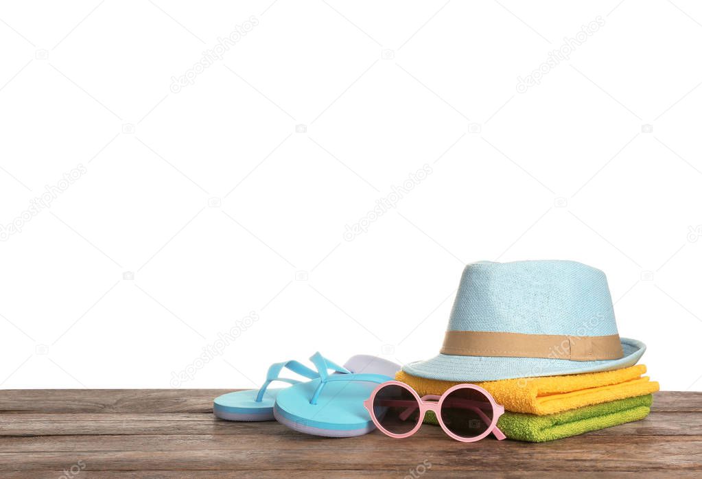 Set of different beach accessories on table against white background. Space for text
