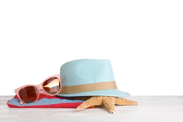 Beach accessories on table against white background. Space for text — Stock Photo, Image