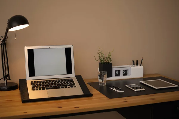 Modern workplace interior with laptop and devices on table. Space for text — Stock Photo, Image