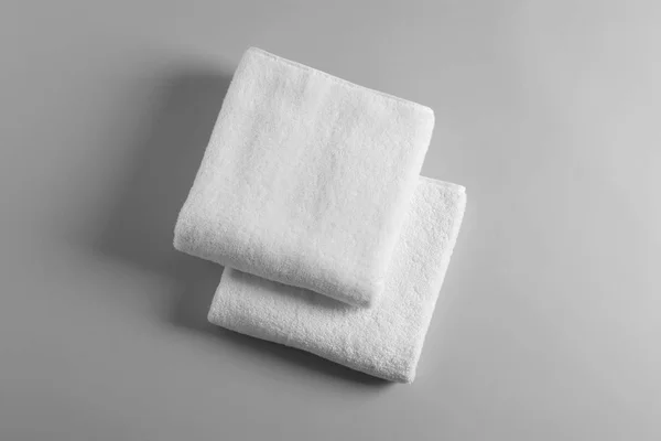 Soft folded towels on light background, top view — Stock Photo, Image