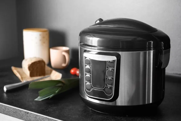 Modern multi cooker and ingredients on table in kitchen, space for text — Stock Photo, Image