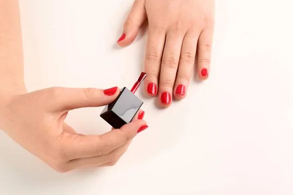 Woman applying nail polish on white background, closeup — Stock Photo, Image